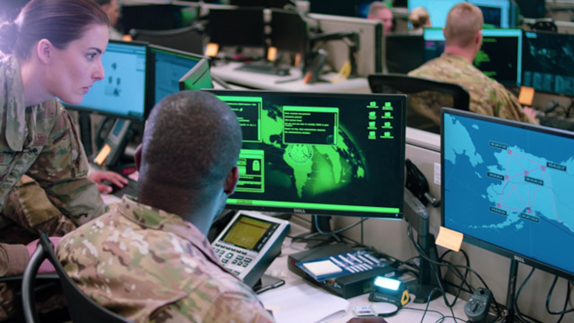 Capt. Sarah Miller and Tech. Sgt. Carrol Brewster, 834th Cyber Operations Squadron, discuss options in response to a staged cyber attack during a drill in June 2019. The Enterprise IT-as-a-Service Integrated Program Office, headquartered at Hanscom Air Force Base, Mass., stood up a Security Operations Center in San Antonio in late February to provide increased cyber threat detection for Buckley Garrison, Colorado, and Offutt Air Force Base, Nebraska. (U.S. Air Force Photo by Maj. Christopher Vasquez)