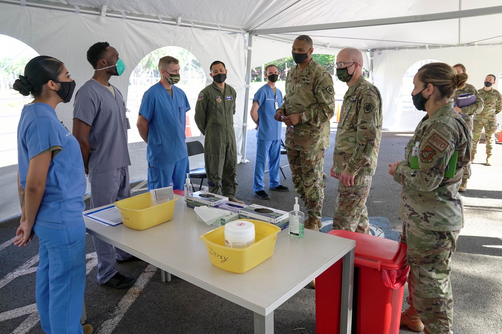 Lt. Gen. Ronald Place, Defence Health Agency director, and Command Sgt. Maj. Michael L. Gragg, Defence Health Agency senior enlisted leader, visit with airmen at 15th Wing Medical Group COVID-19 Clinic at Joint Base Pearl Harbor-Hickam, Hawaii Feb. 26, 2021. The DHA is a joint combat support agency that integrates Army, Navy and Air Force medical services to maintain medical training, health, and readiness. (U.S. Air Force photo by Airman 1st Class Makensie Cooper)