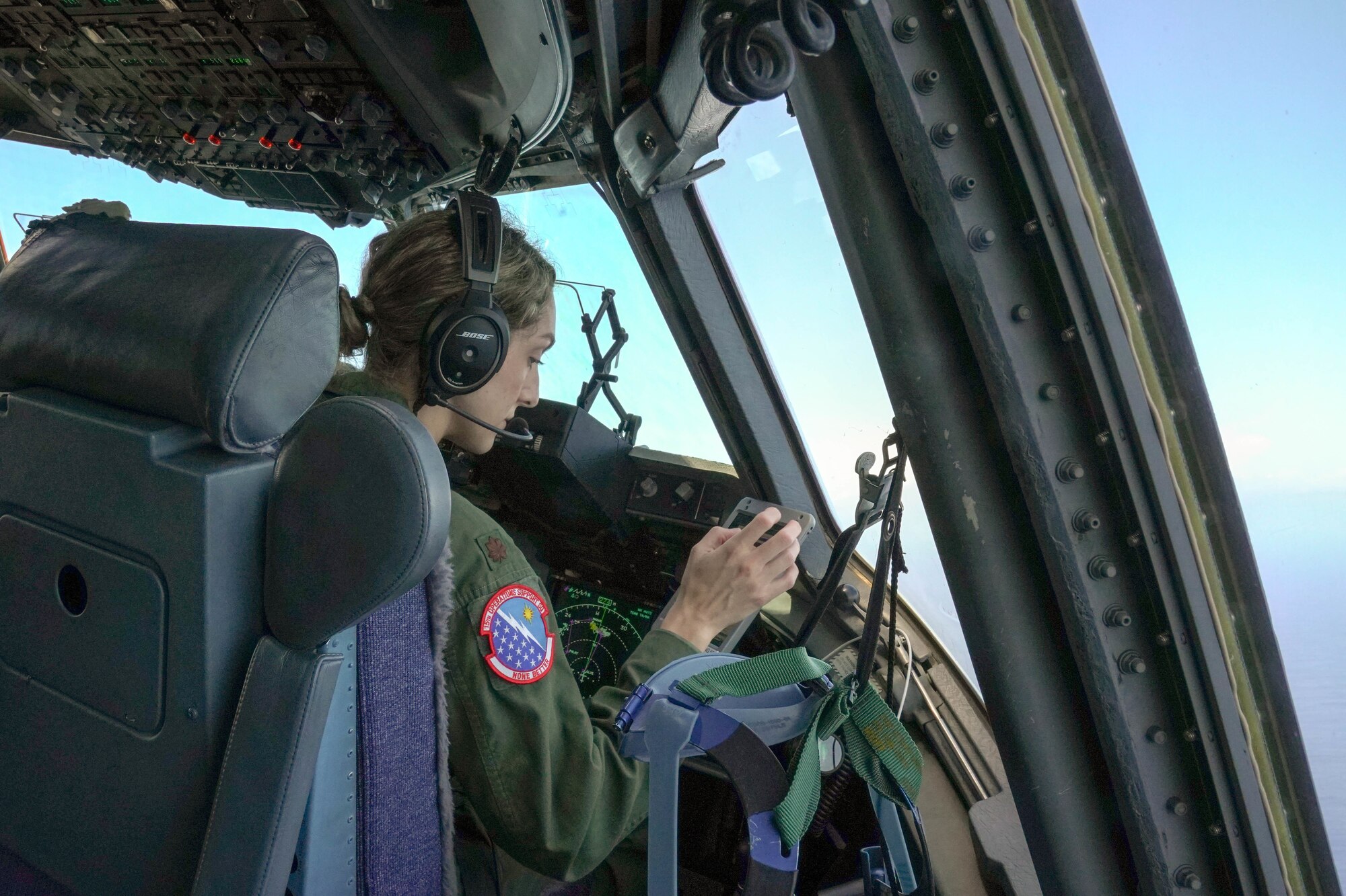 Maj. Jacqueline Cushing, 535th Airlift Squadron instructor pilot, checks the flight course during a training mission around the Hawaiian Islands March 25, 2021. Women from the 535th Airlift Squadron conducted an all-female flight in honor of Women’s History Month celebrating the contributions of female airmen. Women first entered pilot training in 1976 and currently make up 21 percent of the Air Force. (U.S. Air Force photo by Airman 1st Class Makensie Cooper)