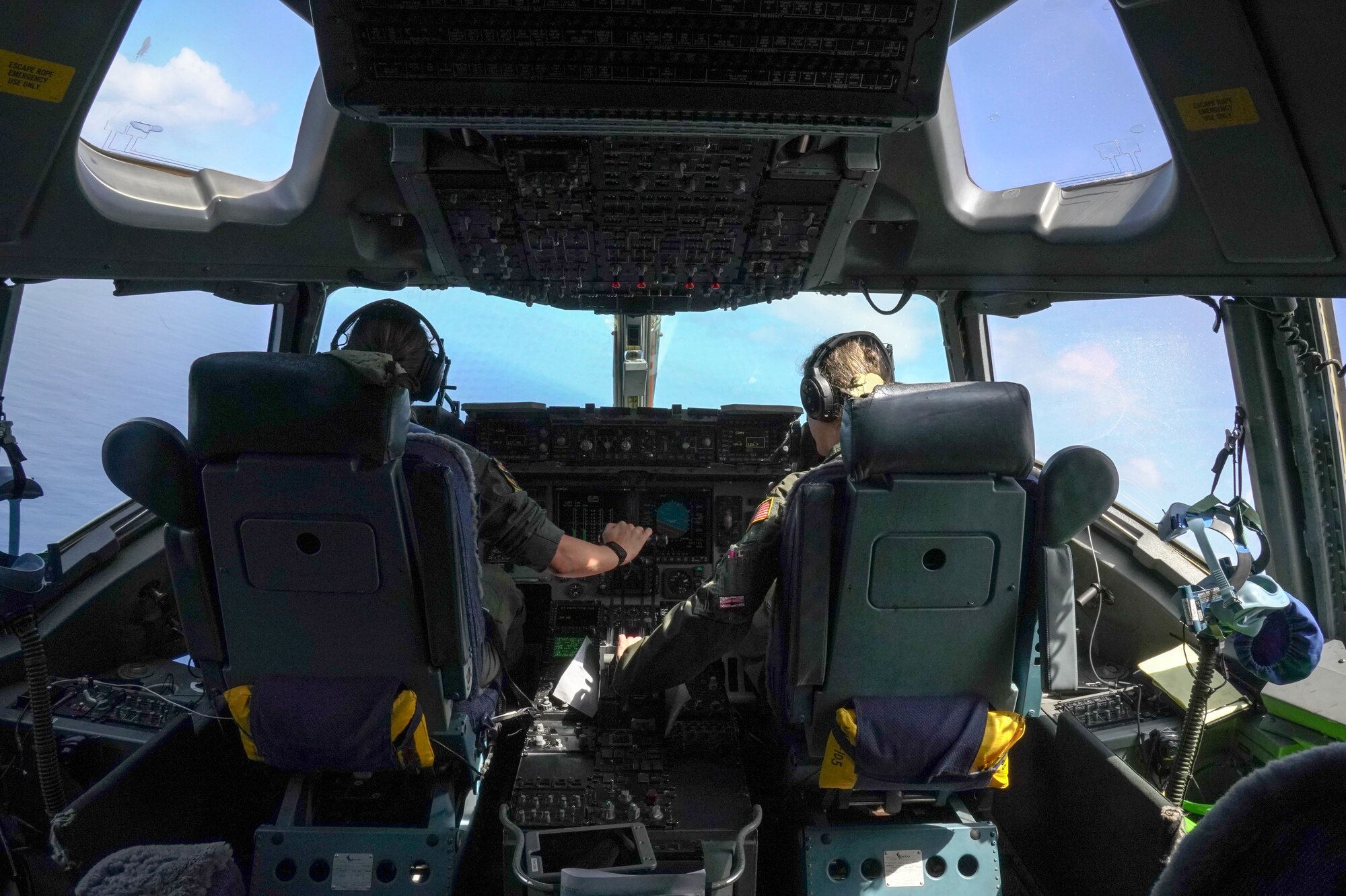 Majs. Brandee Taylor and Jacqueline Cushing, both 535th Airlift Squadron instructor pilots, conduct a training mission around the Hawaiian Islands March 25, 2021. Women from the 535th Airlift Squadron conducted an all-female flight in honor of Women’s History Month celebrating the contributions of female airmen. Women first entered pilot training in 1976 and currently make up 21 percent of the Air Force. (U.S. Air Force photo by Airman 1st Class Makensie Cooper)