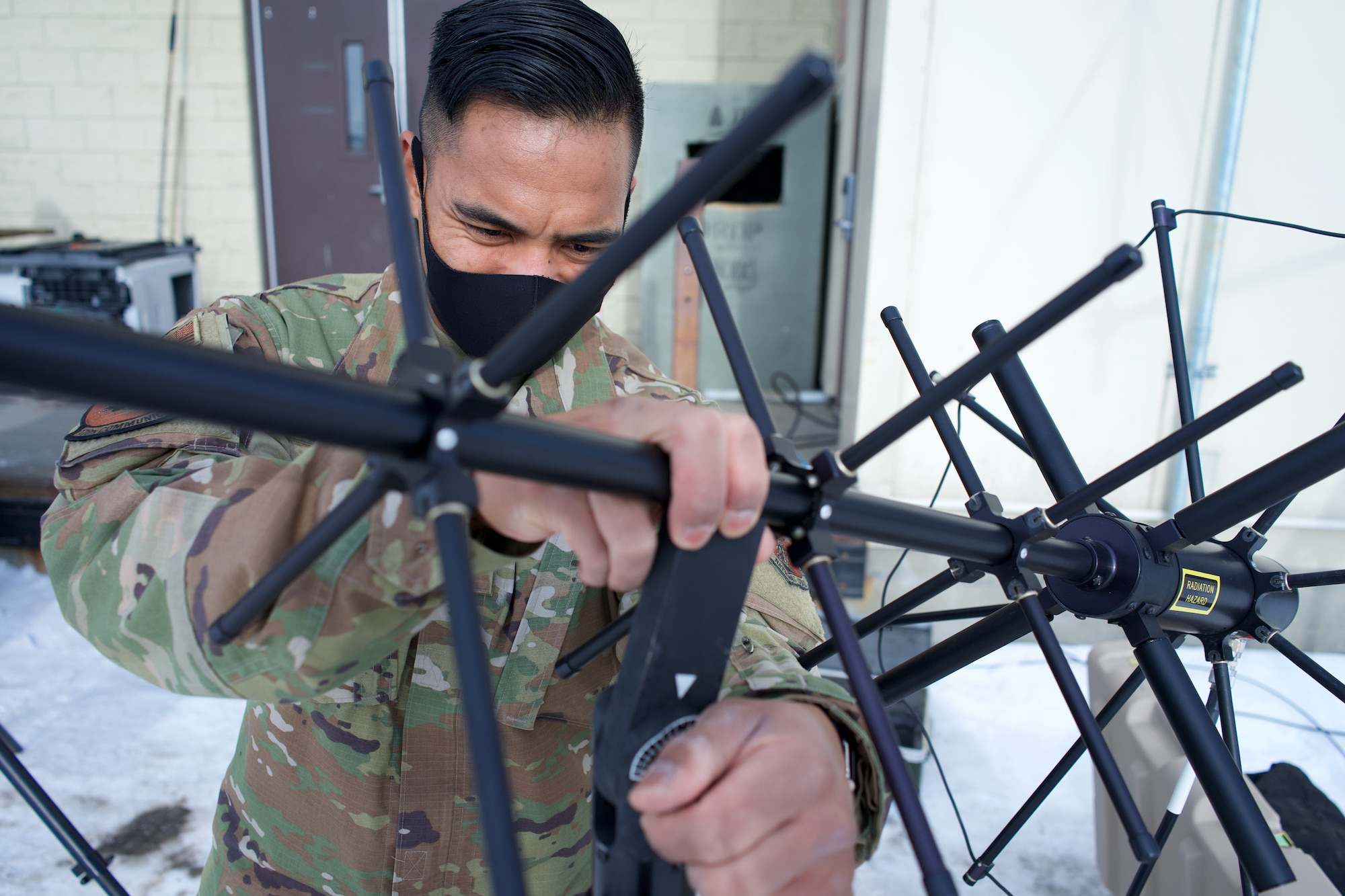 Alaska Air National Guard Staff Sgt. Preston Fernandez, a radio frequency transmission systems technician with 176th Communications Flight, installs a satellite communications antenna March 22, 2021, at Joint Base Elmendorf-Richardson, Alaska. The SATCOM antenna is part of the 176th Wing’s Mobile Rescue Operations Center, a rapidly deployable command-and-control suite that supports rescue operations.