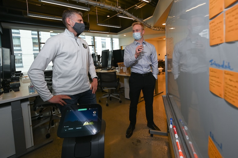 1st Lt. Ben Paulk, (right) a member of the Digital Phantom program and a program manager for AFNWC's Nuclear Command, Control and Communications Integration Directorate at Hanscom Air Force Base, Mass., speaks to Col. Tucker Hamilton, director of the Department of the Air Force-Massachusetts Institute of Technology Artificial Intelligence Accelerator, at its headquarters in Cambridge, Mass., March 26.