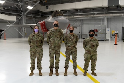 U.S. Army General Daniel R. Hokanson, chief, National Guard Bureau, stands for a portrait alongside Staff Sgt. Sara Basiliere, Master. Sgt. Jessica Mitchell and Master Sgt. Mare Jane Palumbo at the Vermont Air National Guard Base.