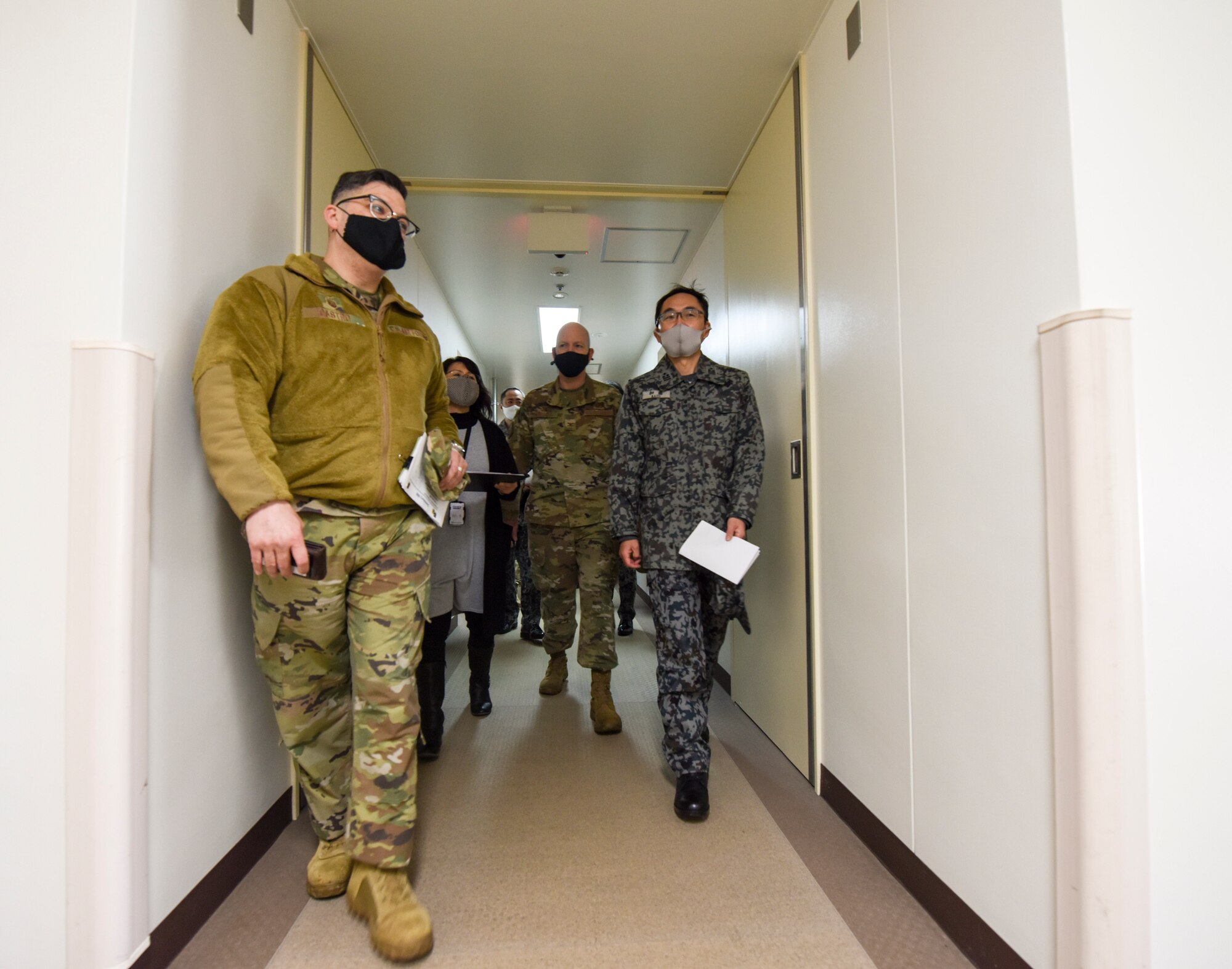 U.S. Air Force Master Sgt. William Castro, left, 35th Civil Engineer Squadron Unaccompanied Housing superintendent, leads a tour of the 35th Fighter Wing Unaccompanied Housing dormitory campus at Misawa Air Base, Japan, Feb. 26, 2021. As they are in the process of upgrading their unaccompanied housing living quarters, the Japan Air Self-Defense Force leaders from the 3rd Air Wing took the tour to gain some perspective on how the 35th Fighter Wing manages its dormitory campus. (U.S. Air Force photo by Tech. Sgt. Timothy Moore)