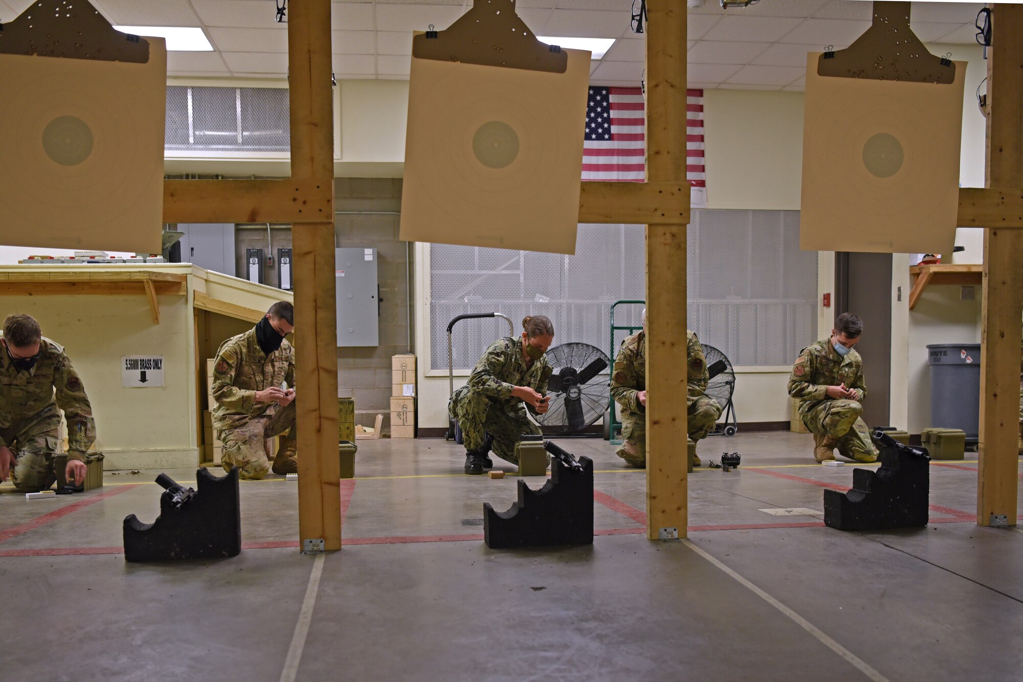 Joint service members load their firearms at the Shooting in Excellence competition at the firing range, on Goodfellow Air Force Base, Texas, March 30, 2021. The competition was designed to challenge participants, build morale and bring services together. (U.S. Air Force photo by Senior Airman Abbey Rieves)