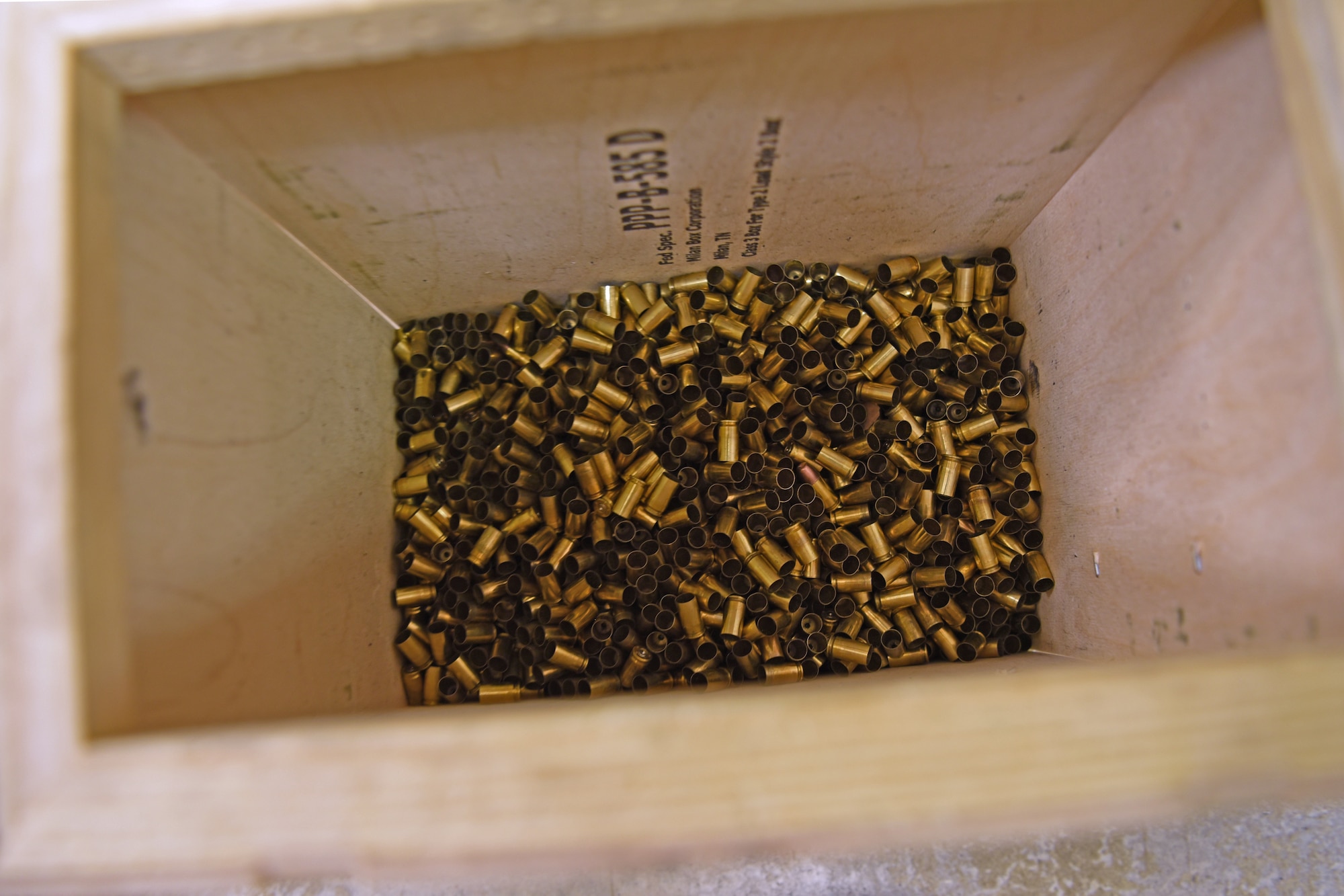 Used bullet casings are disposed of in a bin during the Shooting in Excellence competition at the firing range, on Goodfellow Air Force Base, Texas, March 30, 2021. Each competitor fired 30 rounds throughout variously timed intervals and utilized different firing techniques at the competition. (U.S. Air Force photo by Senior Airman Abbey Rieves)