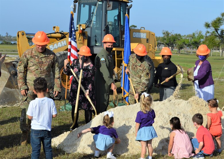 Six future members of the new Tyndall Air Force Base Child Development Center in Florida gather around with their plastic shovels to participate in a groundbreaking ceremony, March 31, 2021.