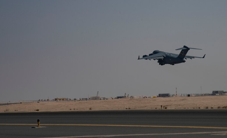 A C-17 Globemaster III assigned to Joint Base Charleston, South Carolina, takes off on the runway April 27, 2021, at Al Udeid Air Base, Qatar.