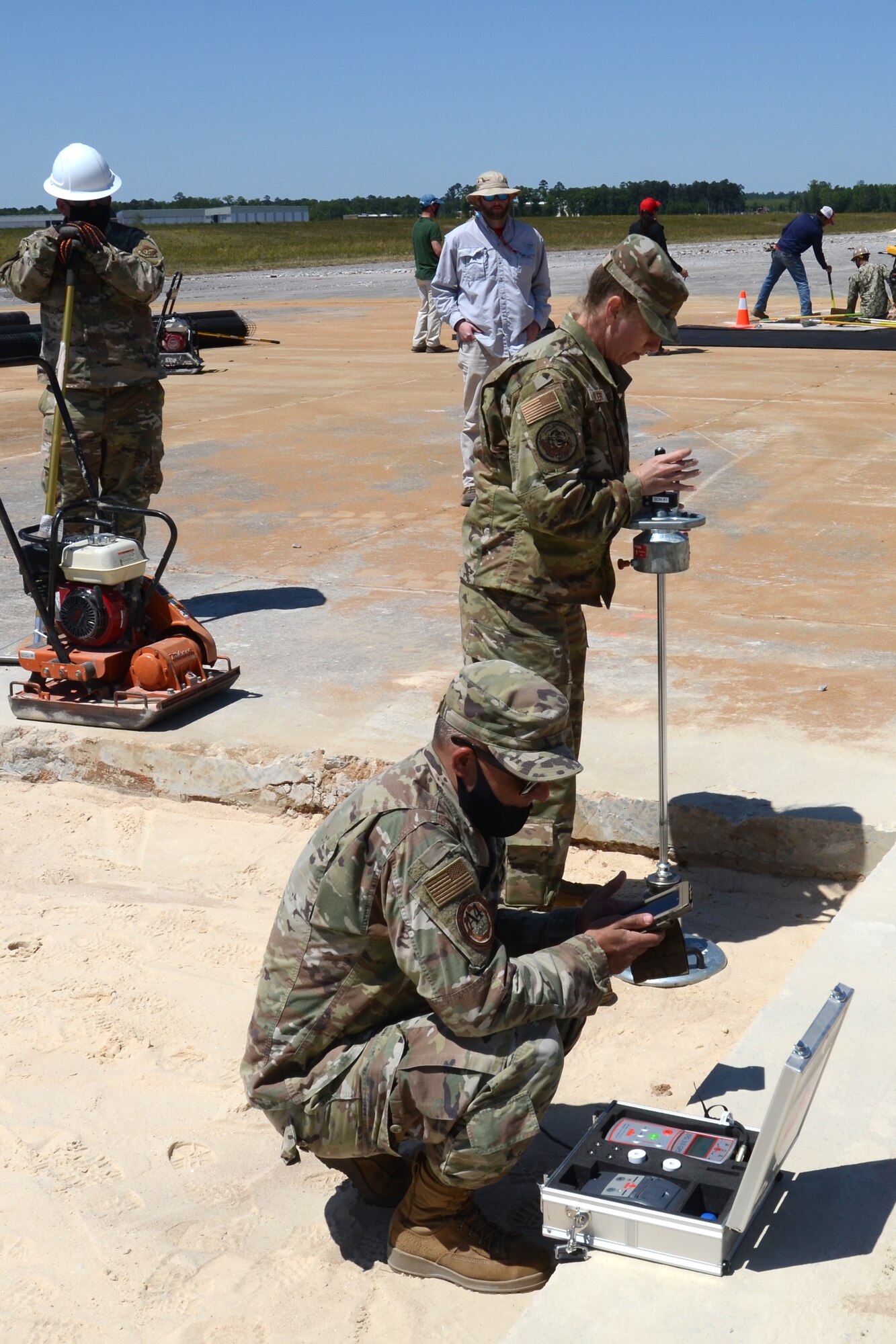 U.S. Air Force Master Sgt. Elizabeth Sailer (middle), 169th Civil Engineer Squadron, works with fellow engineers Senior Master Sgt. Matthew Novak (right), HQ Pacific Air Forces, Joint Base Hickam, Hawaii, and Tech. Sgt. Adam Ballash, 36th Civil Engineer Squadron, Anderson Air Force Base, Guam, to perform a soil test using a Clegg hammer during an Expedient and Expeditionary Airfield Damage Repair (E-ADR) Joint Capability Technology Demonstration at McEntire Joint National Guard Base, South Carolina, April 22, 2021. The demonstration simulates the rapid repair of a battle damaged runway. (U.S. Air National Guard photo by Lt. Col. Jim St.Clair, 169th Fighter Wing Public Affairs)