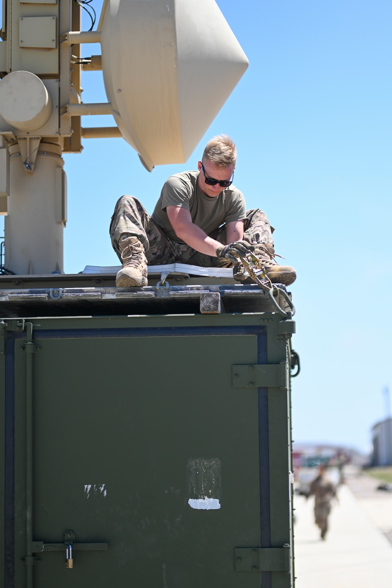 Senior Airman Brendan Hoffman, 727th Special Operations Aircraft Maintenance Squadron ground control station technician, secures a satellite on a shipping container, April 20, 2021, on Point Mugu Naval Air Station, California. Airmen and Guardians from the 49th Wing, Holloman Air Force Base, New Mexico; 452nd Air Mobility Wing, March Air Reserve Base, California; 27th Special Operations Wing, Cannon Air Force Base, New Mexico, and the 432nd Air Expeditionary Wing, Creech AFB, Nevada, joined to execute Exercise Agile Reaper. (U.S. Air Force photo by Senior Airman Kristin Weathersby)