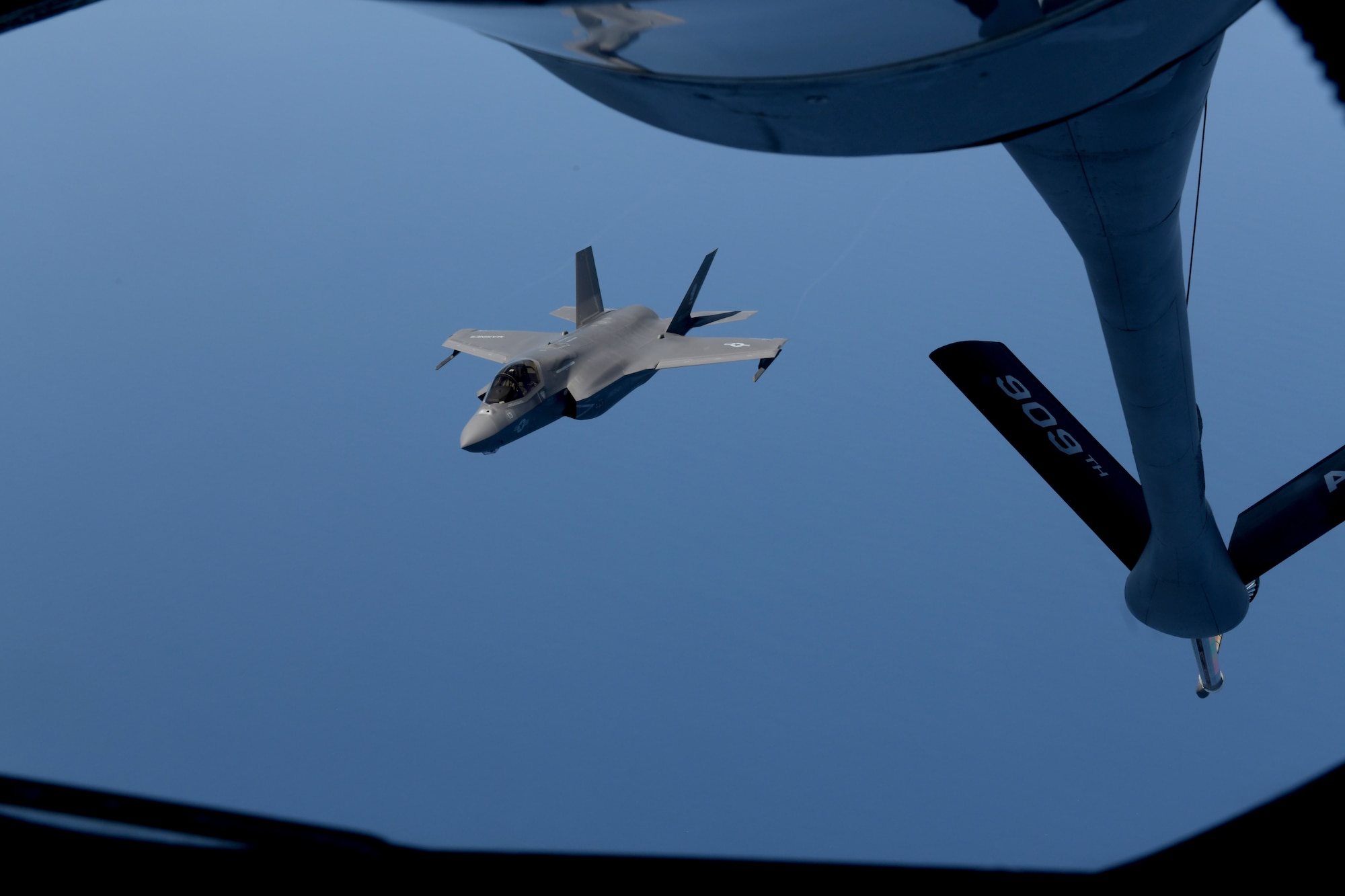 KC-135 from Kadena Air Base, Japan, refuels Marine aircraft during training exercise.