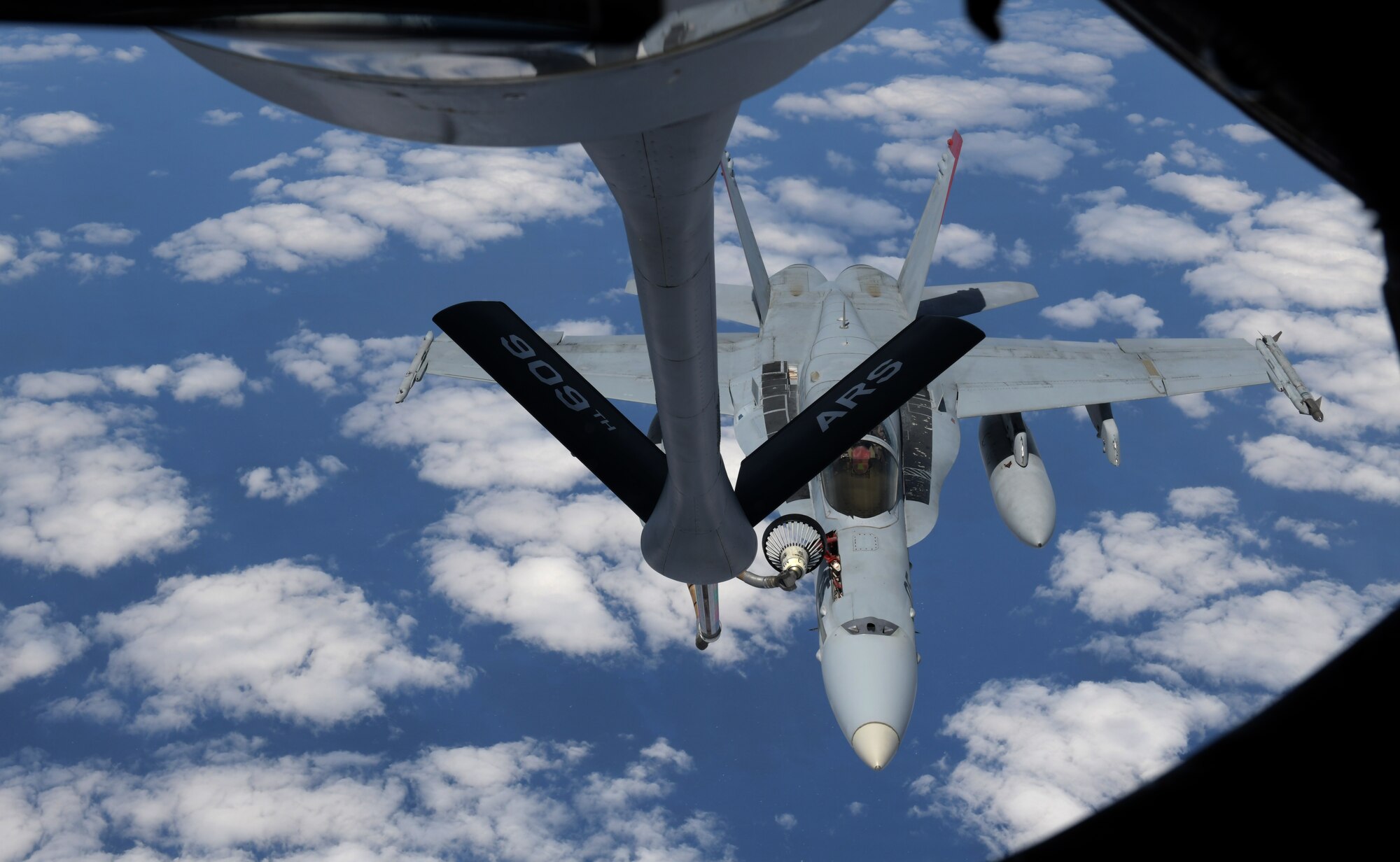 KC-135 from Kadena Air Base, Japan, refuels Marine aircraft during training exercise.