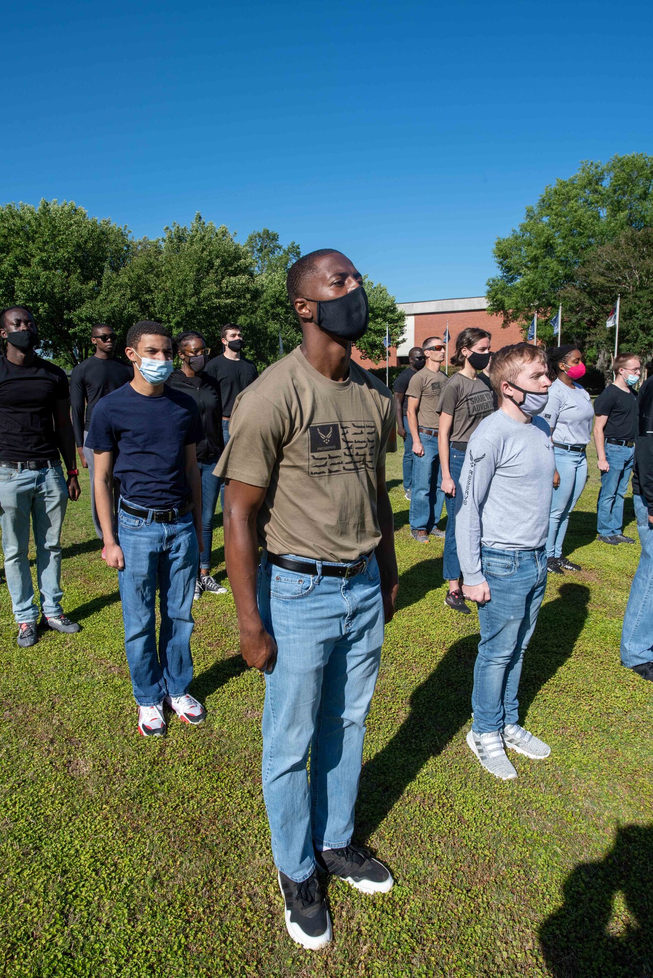 Members of the development and training flight stand at the position of attention while they are being instructed on basic millitary procedures May 1, 2021, at Joint Base Charleston, South Carolina. The development and training flight is desigened to ensure that  Air Force recruits are prepared for basic training prior to shipping out.