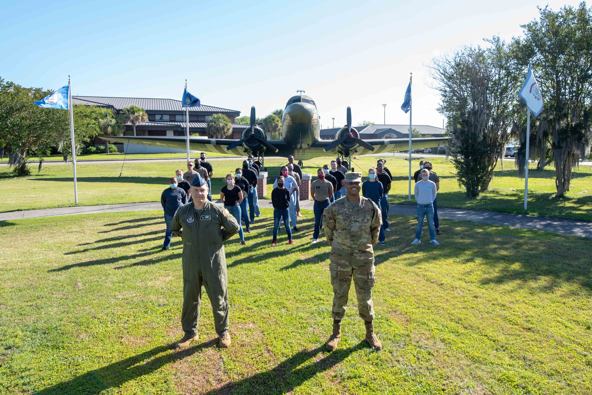 Col. Don L. Thigpen, Vice Commander, 315th Airlift Wing, Joint Base Charleston, South Carolina and Tech. Sgt. Jontae Patterson, Development Training Flight coordinator, 315th Airlift Wing stand at parade rest with the development and training flight in front of a C-47 Skytrain May 1, 2021, here. The development and training flight is desigened to ensure that Air Force recruits are prepared for basic training.