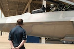 An F-22 crew chief watches on as the pilot prepares to take flight in the aircraft.