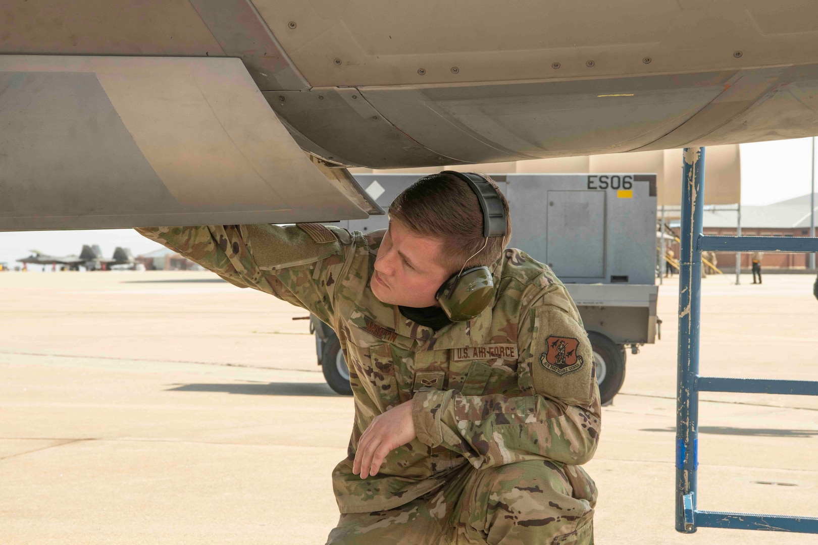 A maintenance airmen inspects a jet before takeoff