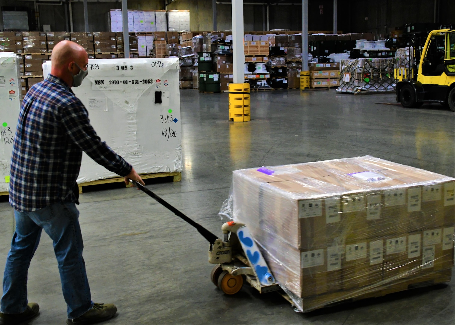 Chris Orth, a production control worker at Defense Logistics Agency Susquehanna in New Cumberland, Pennsylvania, transports the initial shipment of children’s cloth masks April 9, 2021, as part of a White House effort to deliver 25 million masks to food banks and community health centers.