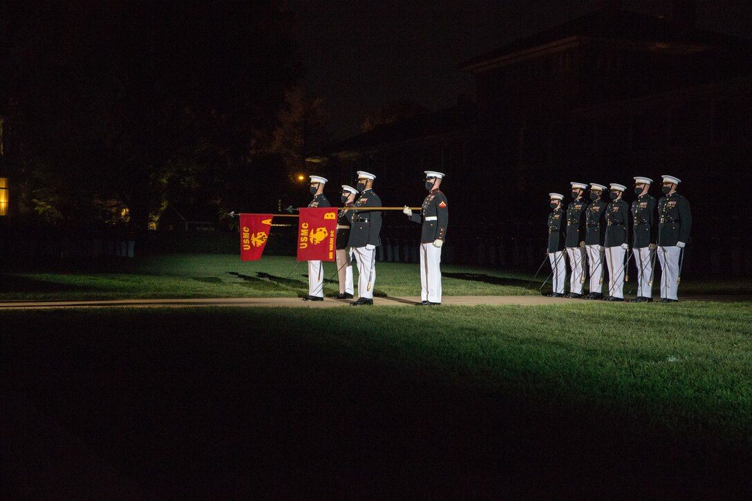 Marines with Alpha and Bravo Companies perform “officers center” during the Friday Evening Parade at Marine Barracks Washington, D.C., April 30, 2021. The Commanding Officer of Marine Barracks Washington Col. Teague A. Pastel was the hosting official, and the 38th Commandant of the Marine Corps Gen. David H. Berger was the guest of honor. (U.S. Marine Corps photo by Lance Cpl. Tanner Lambert)