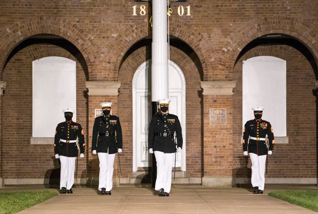 Marines with the parade staff march down center walk during the Friday Evening Parade at Marine Barracks Washington, D.C., April 30, 2021. The Commanding Officer of Marine Barracks Washington Col. Teague A. Pastel was the hosting official, and the 38th Commandant of the Marine Corps Gen. David H. Berger was the guest of honor. (U.S. Marine Corps photo by Lance Cpl. Allen Sanders)