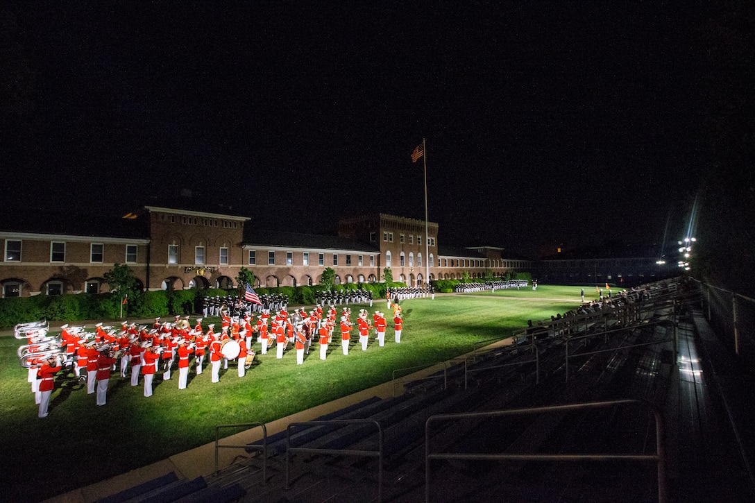 Marines with Marine Barracks Washington stand at attention during “march on the colors” at the Friday Evening Parade at Marine Barracks Washington, D.C., April 30, 2021. The Commanding Officer of Marine Barracks Washington Col. Teague A. Pastel was the hosting official, and the 38th Commandant of the Marine Corps Gen. David H. Berger was the guest of honor. (U.S. Marine Corps photo by Lance Cpl. Allen Sanders)