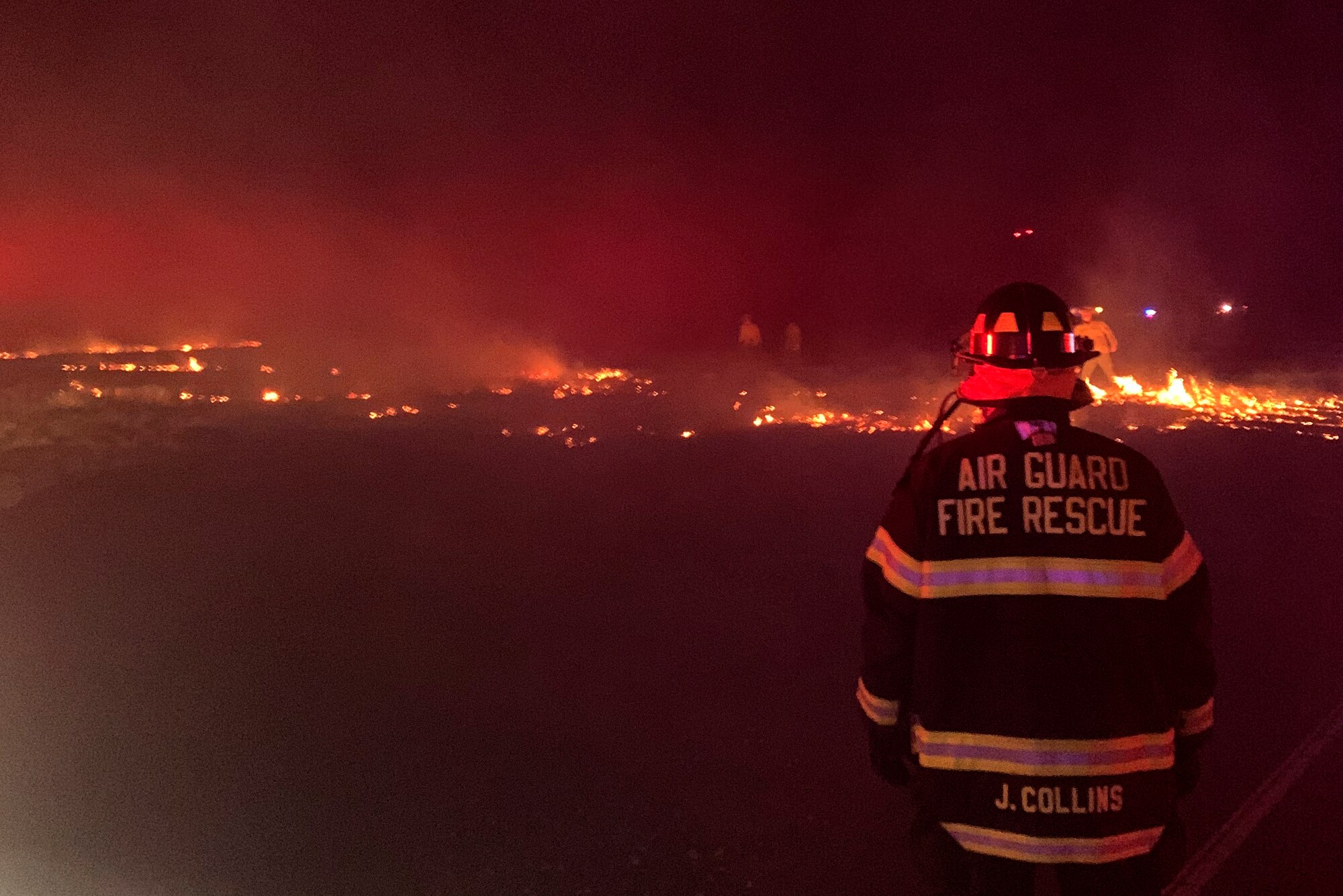 Firefighters with the 177th Fighter Wing respond to a brush fire near Atlantic City Air National Guard Base, N.J., on May 1, 2021. The fire, which was caused by a downed electrical wire, burned nearly 40 acres before being brought under control.