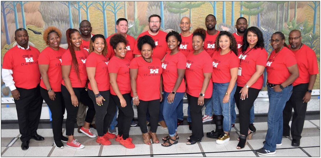 IN THE PHOTO, Memphis District Procurement Analyst TiJuana' TJ' Harris (fourth from the left, front row) poses for a group photo with her Contracting ‘family’ after their Fiscal ‘New Year Party” in September of 2019. Harris was recently provided the chance to apply for a 120-day developmental assignment at the division level, where she said she would learn even more about the "Whys" of USACE contracting.