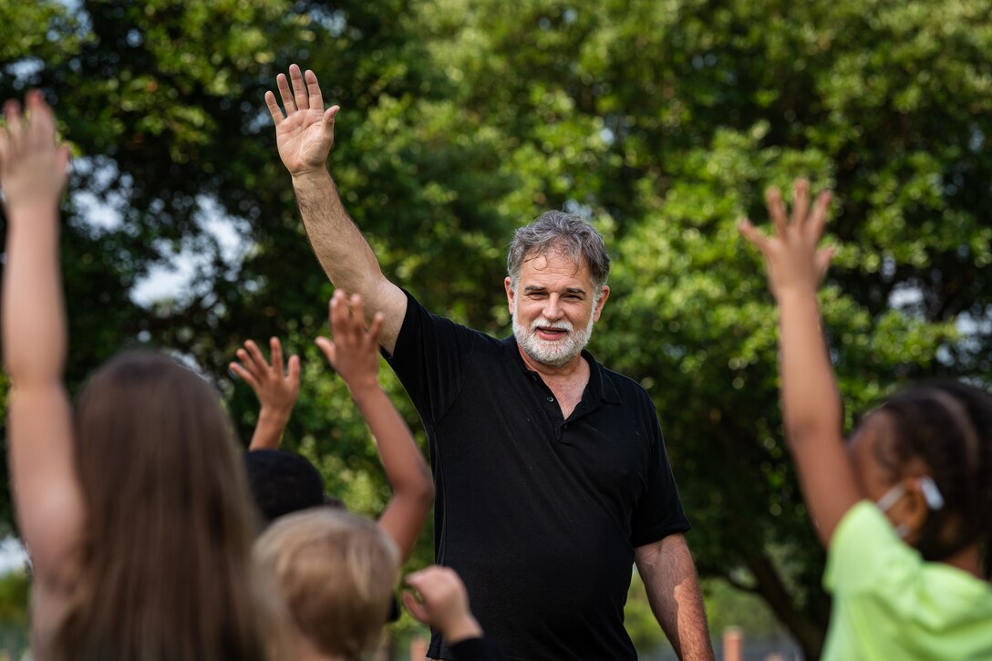 A photo of the base forester interacting with children