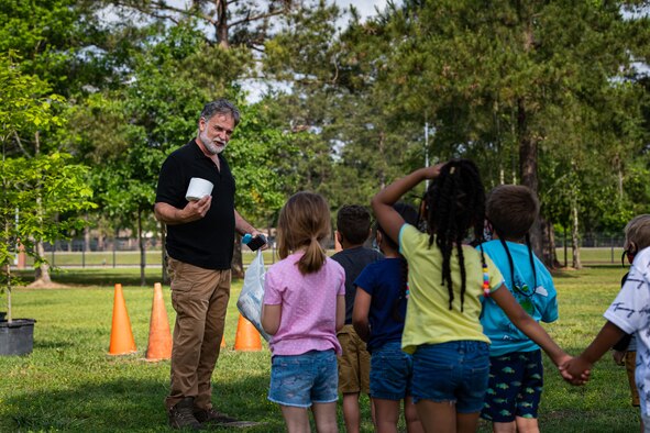 A photo of the base forester speaking to children