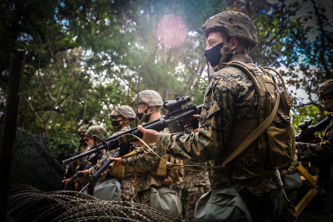 U.S. Marines with guard force, 9th Engineer Support Battalion, 3rd Marine Logistics Group, secure an entry control point during a training iteration for exercise Pacific Pioneer on Kin Blue training area, Okinawa, Japan, April 20, 2021. Pacific Pioneer serves as 9th ESB's Marine Corps Combat Readiness Evaluation as well as an opportunity to demonstrate the ability to establish and sustain expeditionary advanced bases with survivable force protection, practice naval integration, and position long range precision fires and tactical logistics nodes across littoral regions in support of naval operations. 3rd MLG, based out of Okinawa, Japan, is a forward deployed combat unit that serves as III MEF’s comprehensive logistics and combat service support backbone for operations throughout the Indo-Pacific area of responsibility.