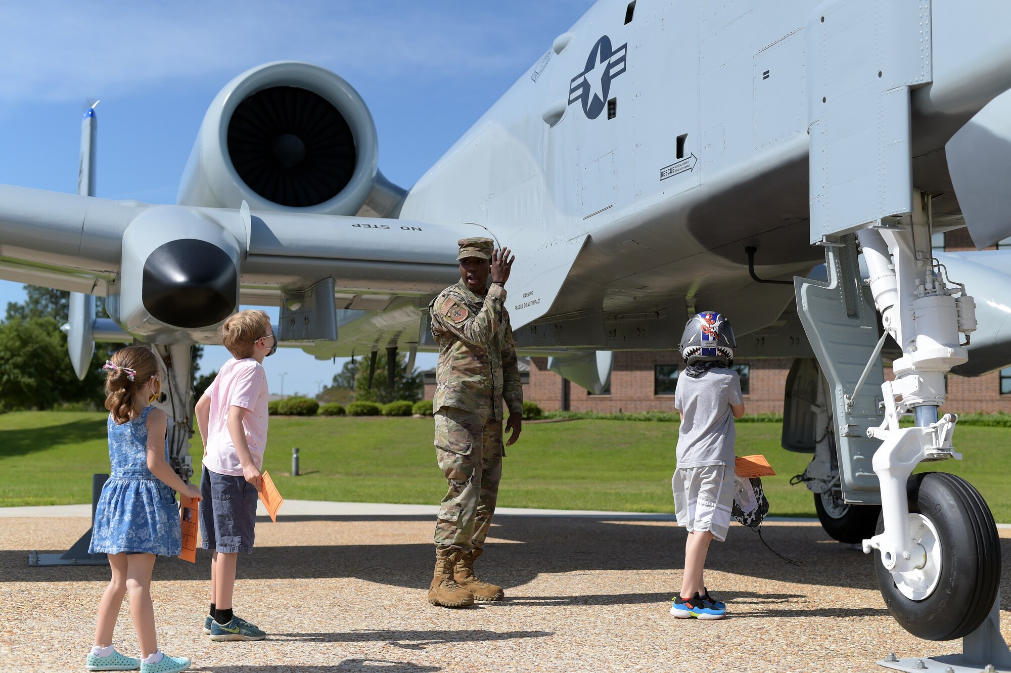 Airman talking to kids about A-10 attack aircraft