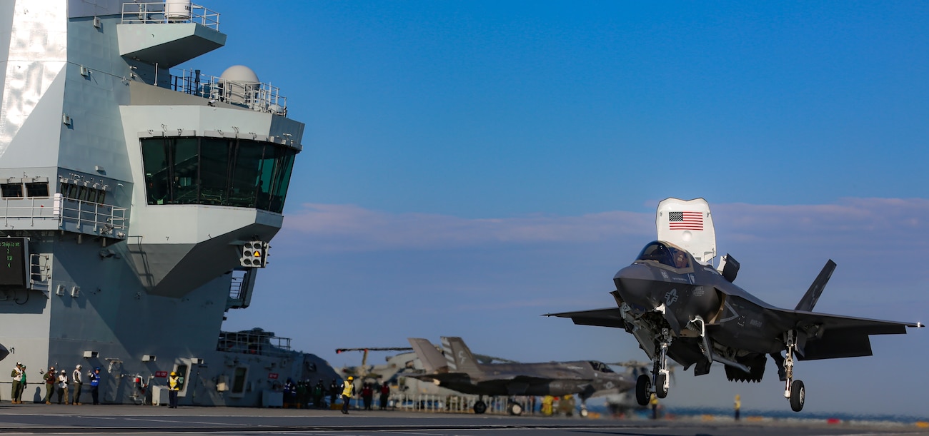 A Marine with Marine Fighter Attack Squadron (VMFA) 211, Carrier Strike Group (CSG) 21 "The Wake Island Avengers" conducts carrier qualifications in an F-35B Joint Strike Fighter Lightning II aboard Her Majesty's Ship (HMS) Queen Elizabeth at sea off the United Kingdom (UK) on 02 May, 2021.  Alongside the UK's 617 Squadron, VMFA-211 will form part of the largest carrier air group in the world.  This deployment highlights the global reach of the U.S. and UK armed forces and their interoperability, and enhances the deterrence and defense capabilities of the NATO Alliance.