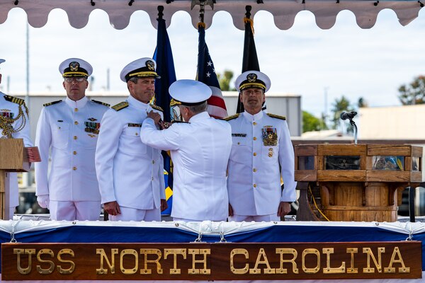 Vice Adm. Scott Conn, commander, U.S. 3rd Fleet, presents the Legion of Merit to Rear Adm. Blake Converse, from Montoursville, Pennsylvania, during a change of command ceremony for Commander, Submarine Force, U.S. Pacific Fleet, held on the brow of the Virginia-class fast-attack submarine USS North Carolina (SSN 777).
