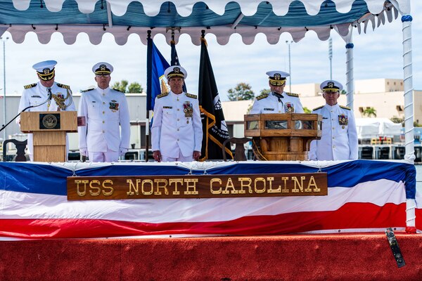 Rear Adm. Jeffrey Jablon, from Frostburg, Maryland, reads his orders during a change of command ceremony for Commander, Submarine Force, U.S. Pacific Fleet, held on the brow of the Virginia-class fast-attack submarine USS North Carolina (SSN 777).