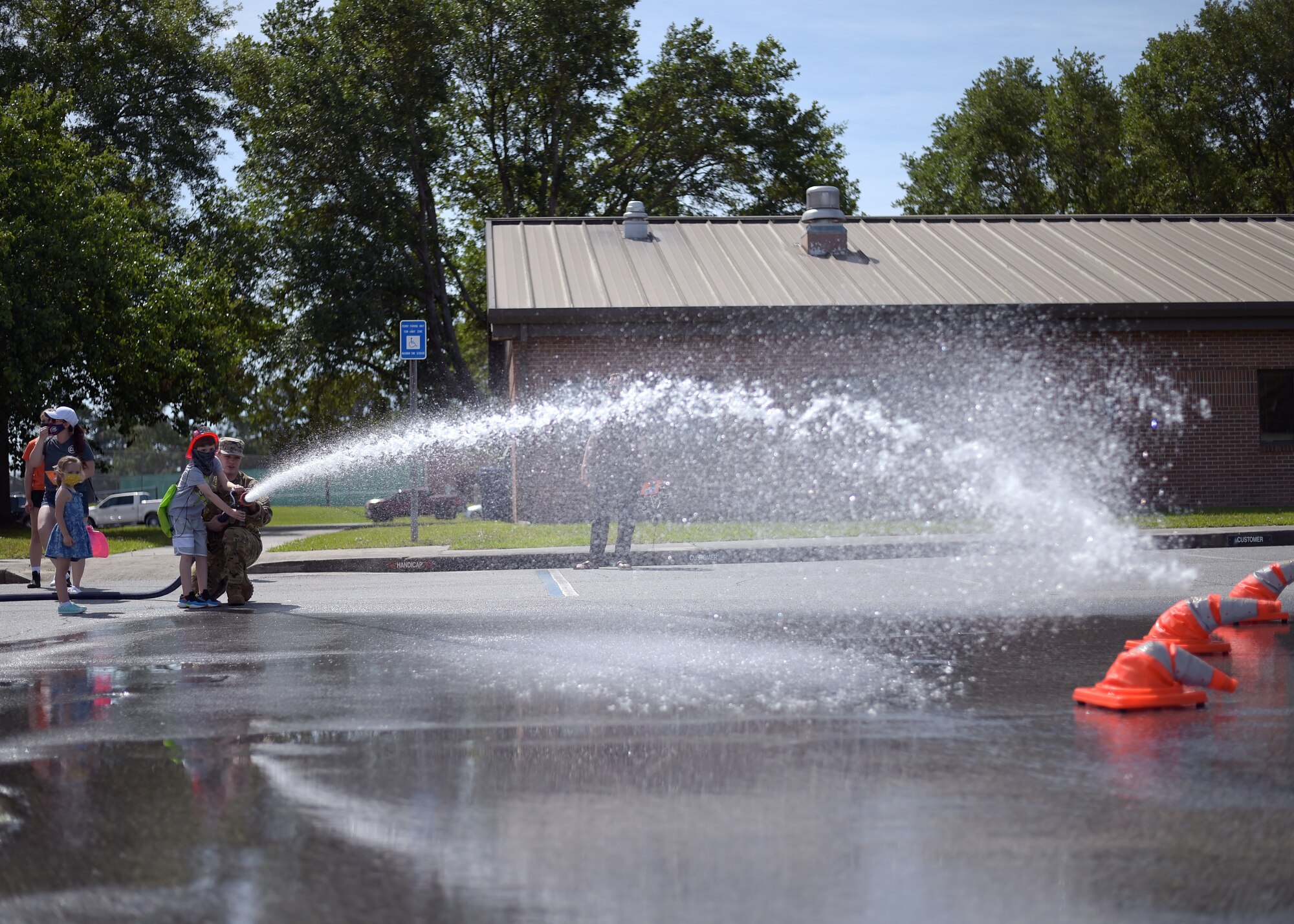 Airman shooting a fire hose