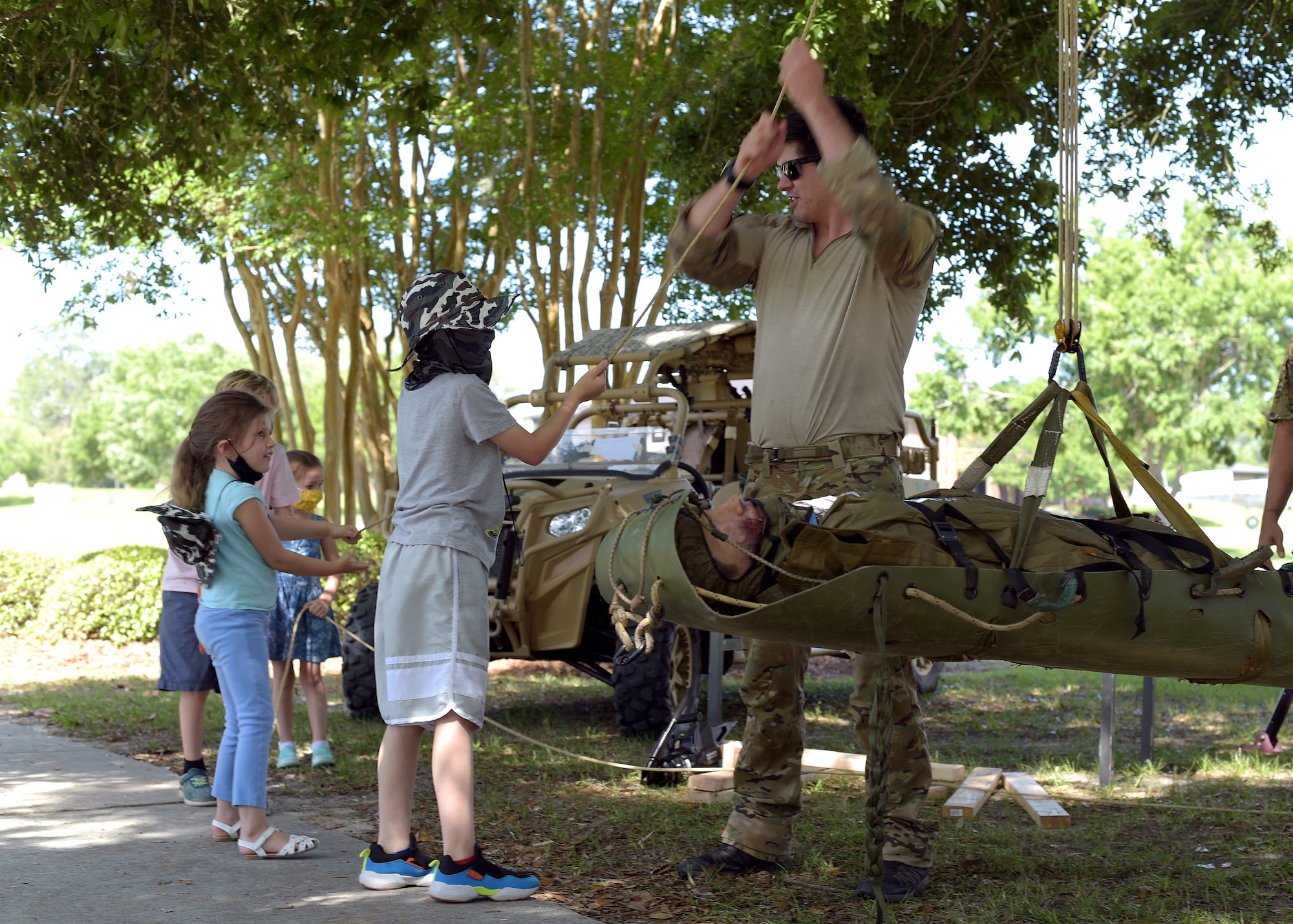 Airman lifting a litter