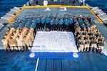 Members of HMCS CALGARY stand with 1286kg of heroin seized from a dhow during a counter-smuggling operation on 23 April, 2021 in the Arabian Sea during OPERATION ARTEMIS and as part of Combined Task Force 150.

Please credit: Corporal Lynette Ai Dang, Her Majesty's Canadian Ship CALGARY, Imagery Technician
©2021 DND/MDN CANADA