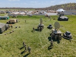 Soldiers assigned to  the New York Army National Guard's  Bravo Company, 101st Expeditionary Signal Battalion, bring satellite stations online at Regional Support Camp Nighthawk, in Nineveh, Ind., April 19, 2021, as part of the Guardian Response 21 exercise at Muscatatuck Urban Training Center. New York National Guard Soldiers supported other state National Guard elements during the exercise.