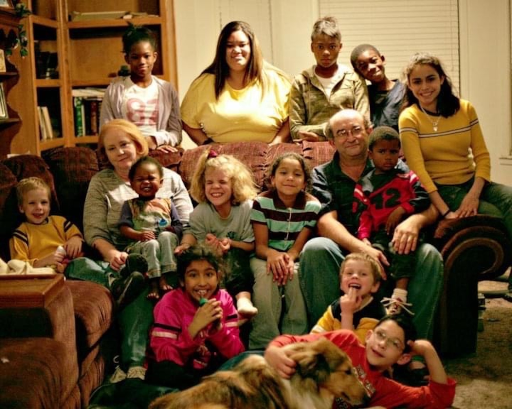 Airman 1st Class Jessica Makenna Martinez Greenlee, 36th Force Support Squadron services journeyman, bottom left, poses for a photo with her parents, Lonny and Donna Greenlee and 12 of her 20 other siblings from the Greenlee home in Wolfforth, Texas, November 24, 2005. Greenlee was placed in foster care at the age of three with three of her siblings. After being in a few homes, a couple from Lubbock, Texas showed interest in adopting all four of them, giving them the chance to grow up together with the company of 19 other children they had and adopted. (Courtesy photo)