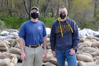 210430-N-EJ843-0120 GROTON, Conn. (April 30, 2021) Naval Submarine Base (SUBASE) New London Commanding Officer Capt. Todd Moore and Naval Submarine School (SUBSCOL) Executive Officer Cmdr. Karl Hassenfratz poses for a photo outside during a base wide clean-up event. Sandbags were filled up by Sailors to prepare for hurricane season as part of a volunteer event in recognition of Earth Day.. (U.S. Navy photo by Mass Communications Specialist Seaman Jimmy Ivy III/Released)