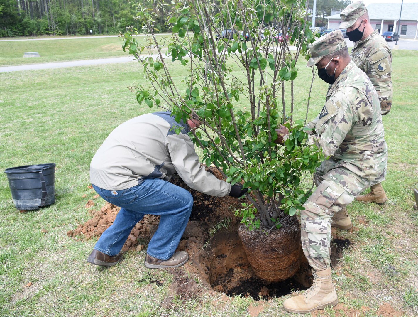 Virginia National Guard Soldiers and civilian employees of Maneuver Training Center Fort Pickett plant two trees at the MTC garrison headquarters in honor of Earth Day April 22, 2021, at Fort Pickett, Virginia.