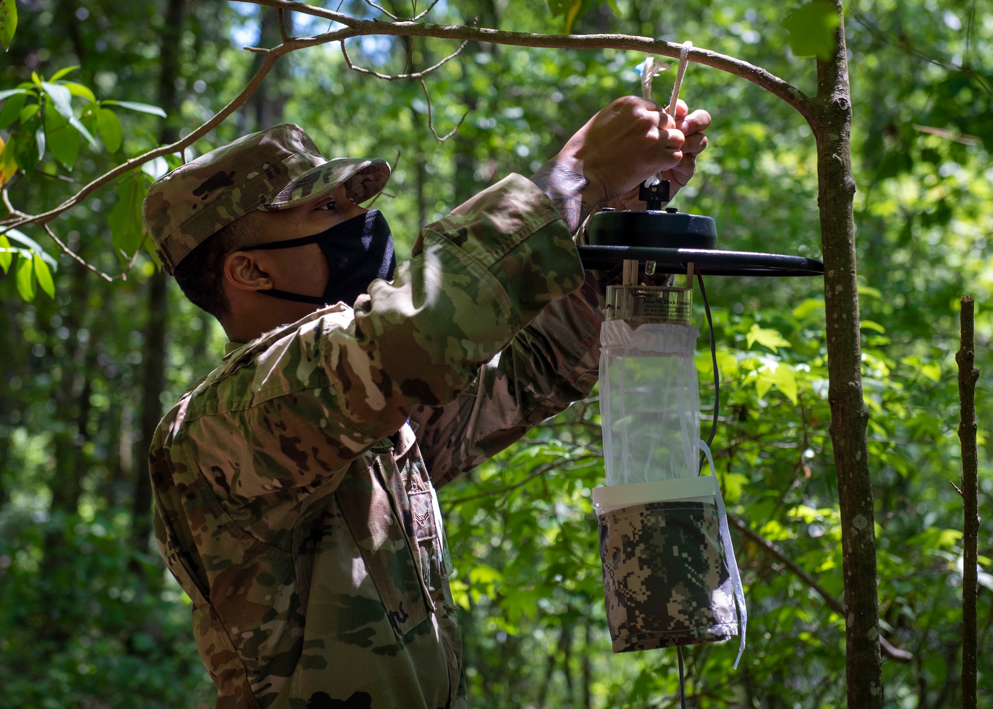 Airman 1st Class Ziaire Buchanan, 4th Operational Medical Readiness Squadron public health technician, sets out a Center for Disease Control light trap for vector surveillance at Seymour Johnson Air Force Base, North Carolina, April 29, 2021.