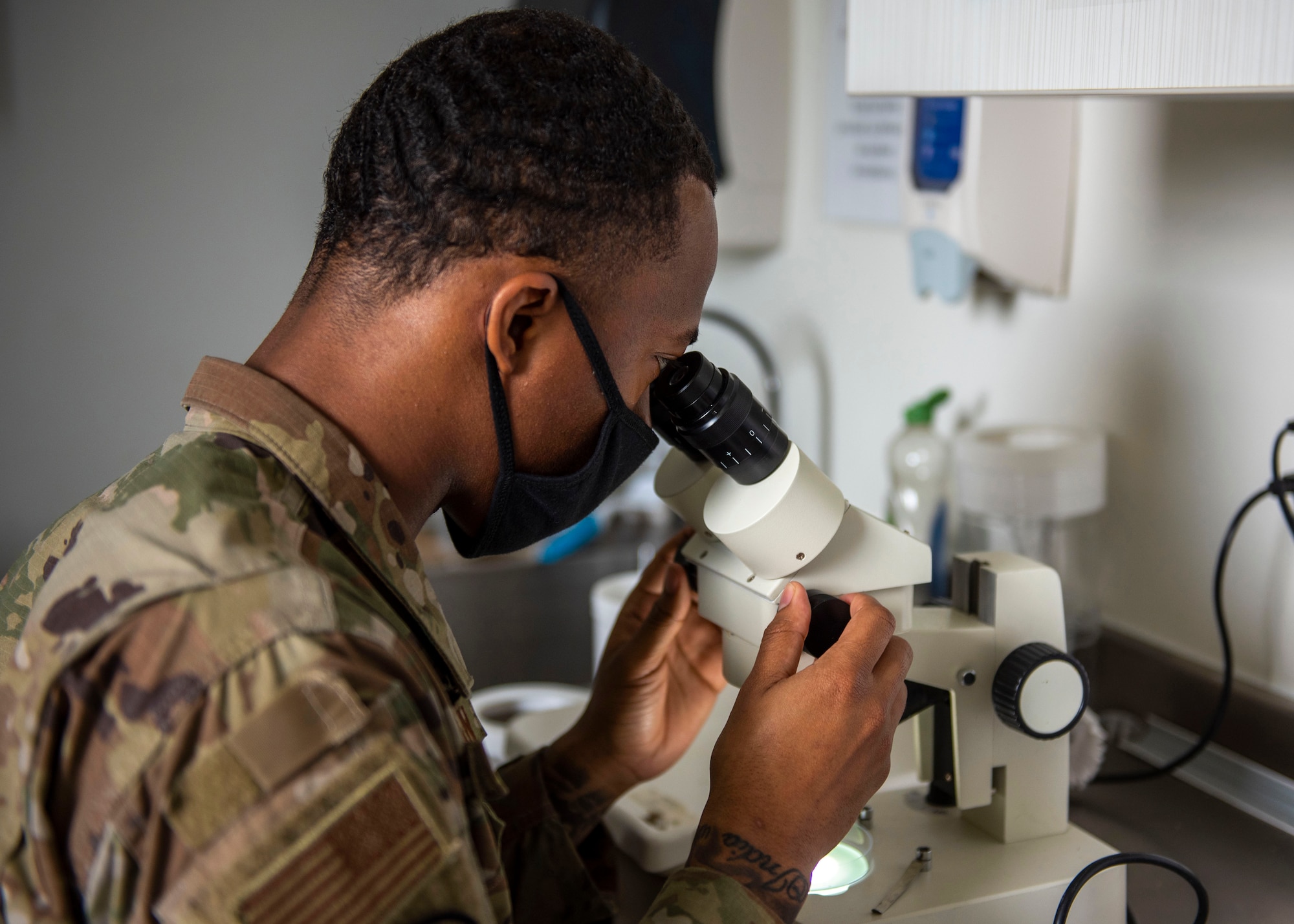 Airman 1st Class Ziaire Buchanan, 4th Operational Medical Readiness Squadron public health technician, looks through a microscope at Seymour Johnson Air Force Base, North Carolina, April 29, 2021.