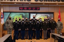 photos of an army badge and group of Soldiers receiving their badge.