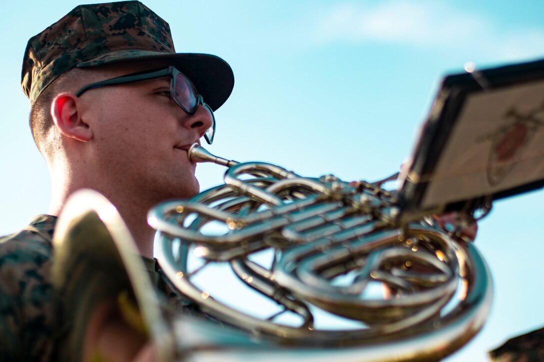 A Marine plays an instrument.