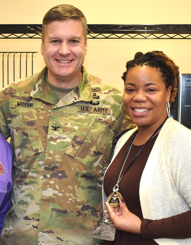 IN THE PHOTO, Memphis District Commander Col. Zachary Miller (left) coins Procurement Analyst TiJuana' TJ' Harris in January of 2020 for going above and beyond in her work. Harris was recently provided the chance to apply for a 120-day developmental assignment at the division level, where she said she would learn even more about the "Whys" of USACE contracting.