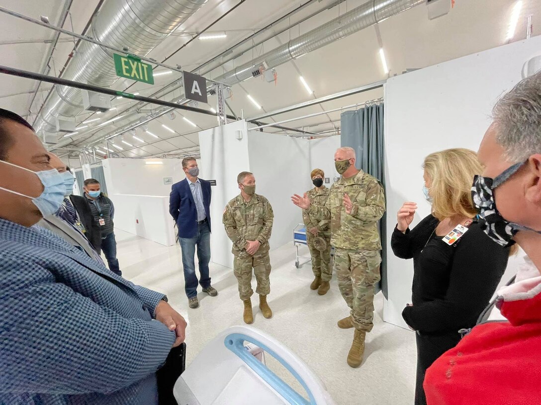 Maj. Gen. Jeffrey Milhorn, U.S. Army Corps of Engineers deputy commanding general for Military and International Operations, center left, listens as Brig. Gen. Paul Owen, the Corps' South Pacific Division commander, center right, talks about the Corps' FEMA mission in support of LA-area hospitals during an April 28 tour of Adventist Health White Memorial Hospital in the Boyle Heights neighborhood of Los Angeles.