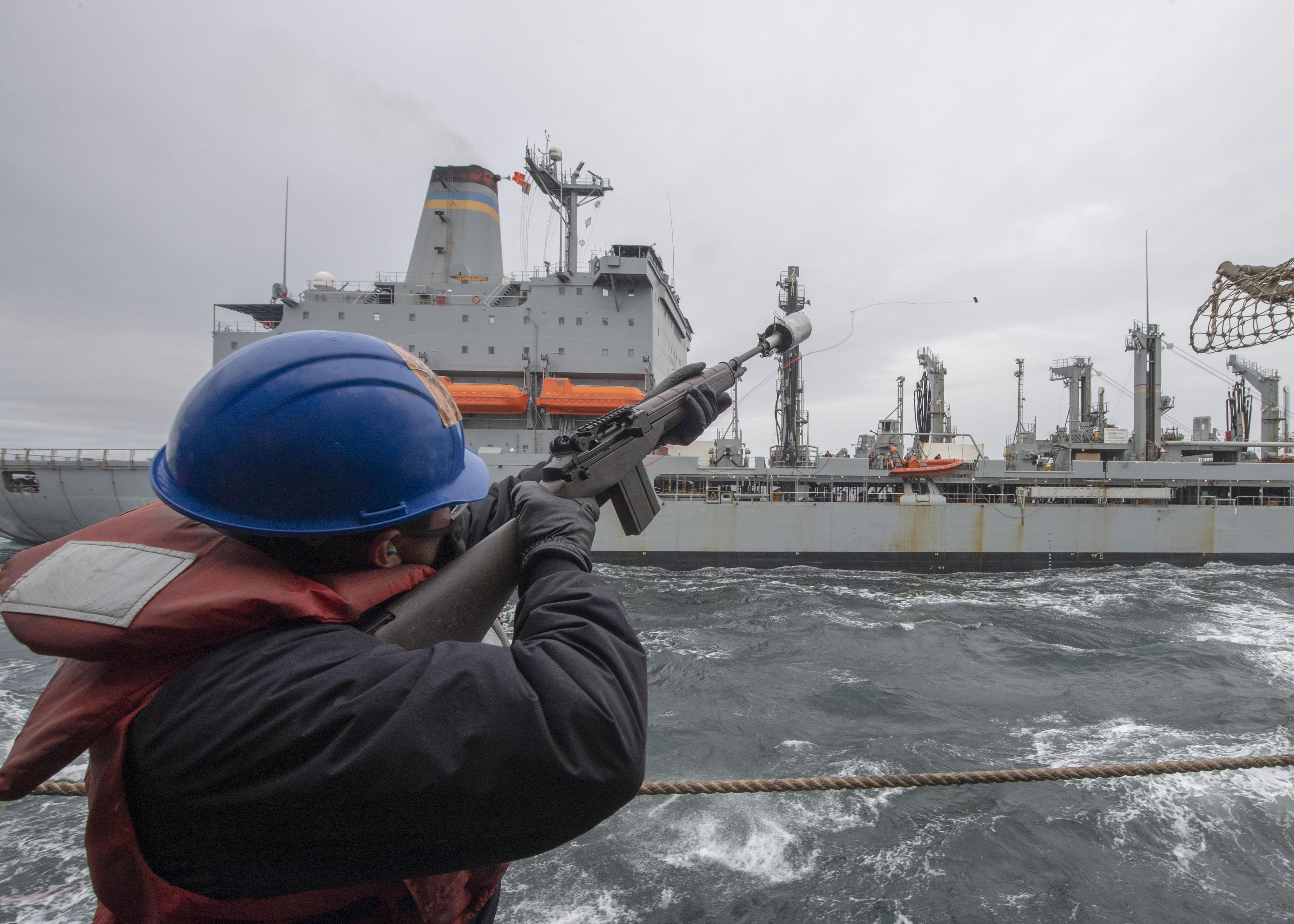 Fire Controlman 3rd Class Henry Serratos, from Santa Rosa, Calif., fires a shot line from the Ticonderoga-class guided-missile cruiser USS Bunker Hill (CG 52) to the Henry J. Kaiser-class fleet replenishment oiler USNS Guadalupe (T-AO 200) during a replenishment-at-sea.
