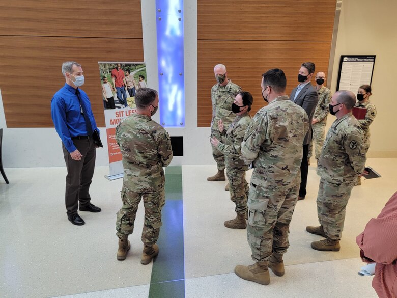 Weed Army Community Hospital’s Commander Col. Nancy Parson, center right, briefs U.S. Army Corps of Engineers Deputy Commanding General for Military and International Operations Maj. Gen. Jeffrey L. Milhorn, second from left, during an April 26 tour of the hospital at Fort Irwin, California.