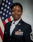 woman posing in front of a flag