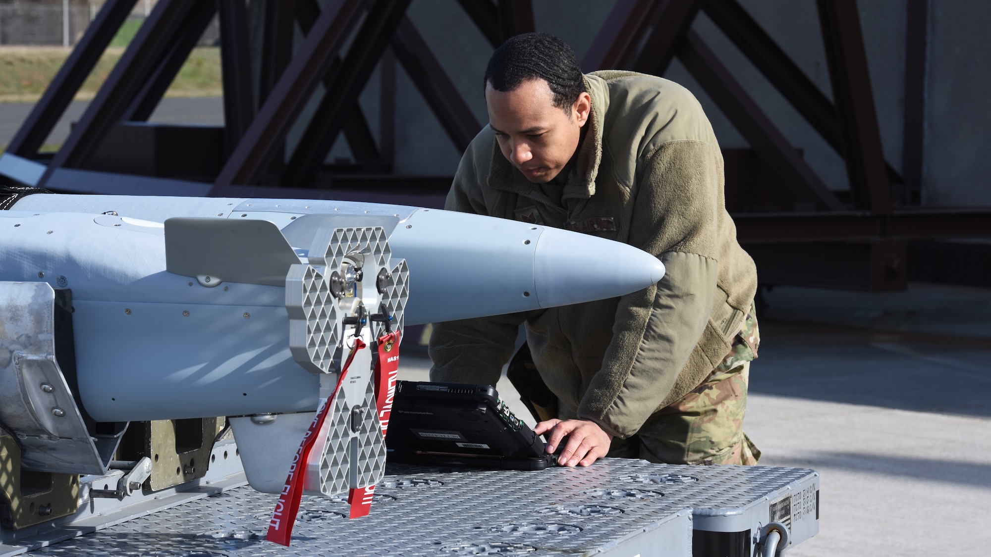 U.S. Air Force Tech Sgt. Keith Rochford, 52nd Aircraft Maintenance Squadron weapons load crew team chief, reviews technical orders before loading two ADM-160C Miniature Air Launched Decoy missiles during an exercise at Spangdahlem Air Base, Germany, April 27, 2021. 52nd AMXS Airmen participated in the exercise that saw a number of squadrons work together to load live munitions onto a U.S. Air Force F-16 Fighting Falcon. (U.S. Air Force photo by Tech. Sgt. Tony Plyler)